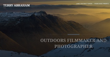 A professional photograph of a mountain landscape at dawn with mist in the lower valleys.